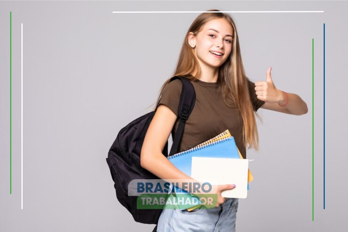 Uma estudante segurando seu material escolar fazendo sinal de positivo para o Desenrola FIES