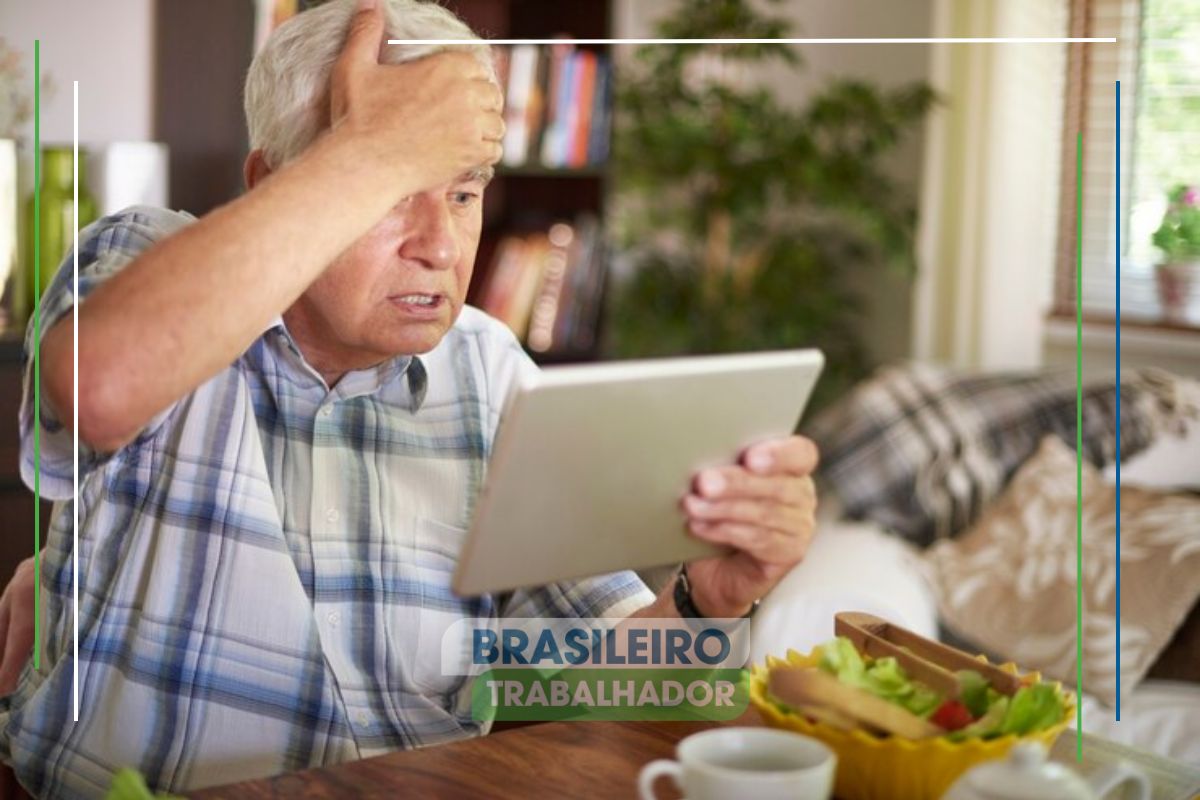 Um senhor com seu tablet na mão e aparentemente irritado enquanto usa um dos Bancos odiados por todos os IDOSOS