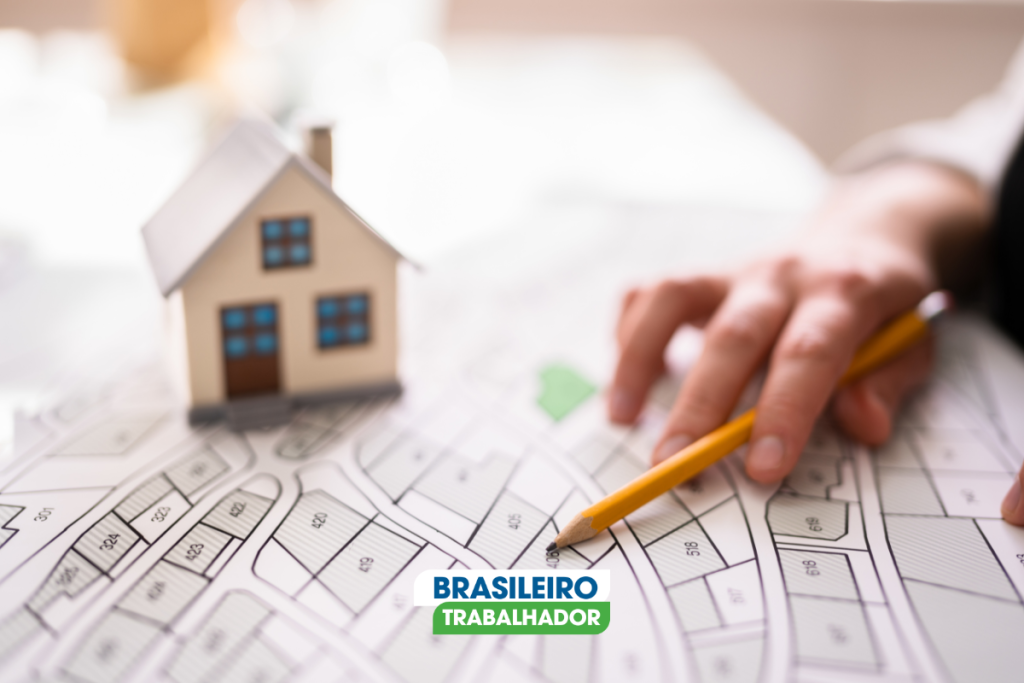Casa do CDHU em maquete com mão planejando obra